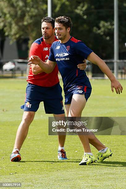 Jesse Hogan does some one on one work with assistant coach Jade Rawlings during a Melbourne Demons AFL pre-season training session at AAMI Park on...