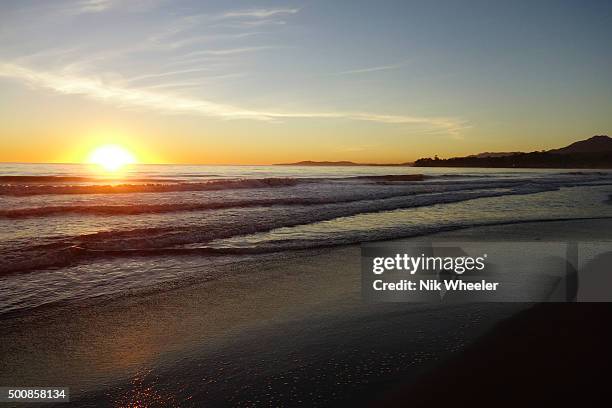 Sun sets over Pacific Ocean at beach on central coast of California, Santa Barbara County, USA