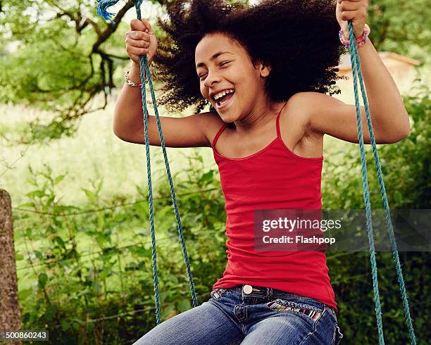 girl having fun on a swing - girl in tank top stock pictures, royalty-free photos & images