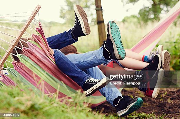 group of boys having fun on a hammock - tween heels stock pictures, royalty-free photos & images