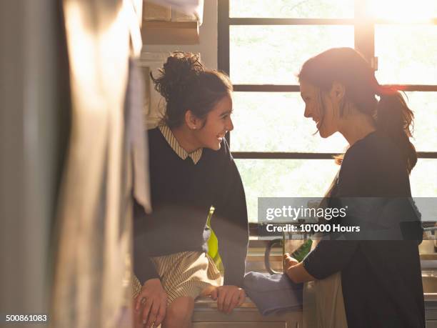 a school girl and her mother laughing together - asian and indian ethnicities imagens e fotografias de stock