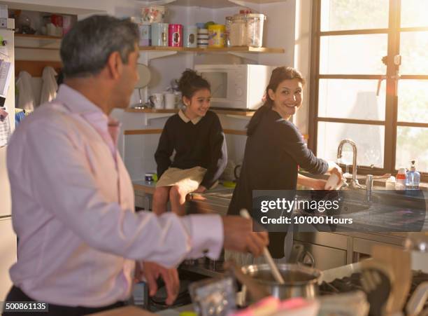 family chatting and cooking an evening meal - indian ethnicity family stock pictures, royalty-free photos & images