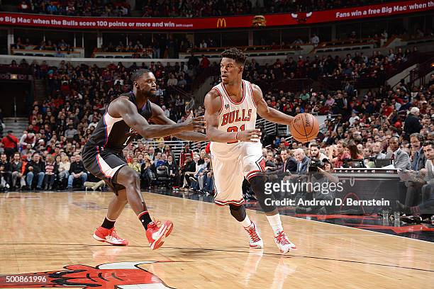 Jimmy Butler of the Chicago Bulls handles the ball against Lance Stephenson of the Los Angeles Clippers on December 10, 2015 at the United Center in...
