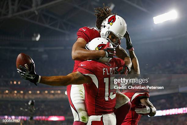 Wide receiver Michael Floyd of the Arizona Cardinals celebrates with wide receiver Larry Fitzgerald after scoring a 42 yard touchdown during the...