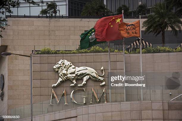 The flags of Macau, left, China, center, and the MGM Macau casino resort, operated by MGM China Holdings Ltd., fly in front of the property in Macau,...