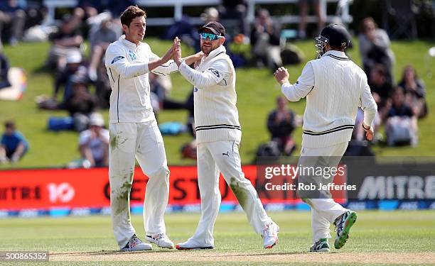 Mitchell Santner of New Zealand celebrates with Brendon McCullum after taking the wicket of Dimuth Karunaratne of Sri Lanka during day two of the...