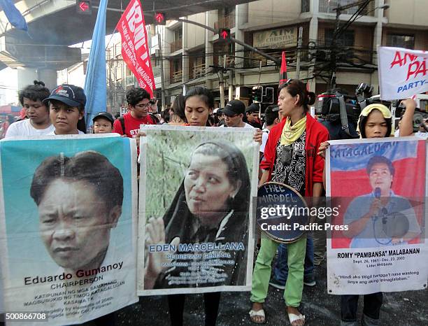 Relatives of victims of extra-judicial killings during the term of former Philippine President Gloria Macapagal-Arroyo hold portraits of their loved...