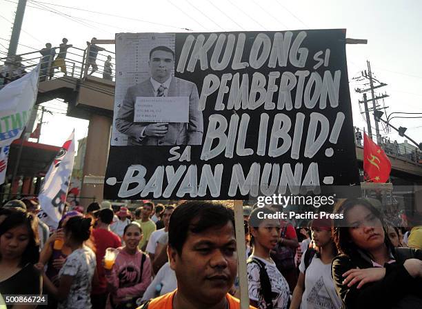 Filipino protester holds a placard calling for Joseph Scott Pemberton to be jailed inside the New Bilibid Prison, a national penitentiary, during a...