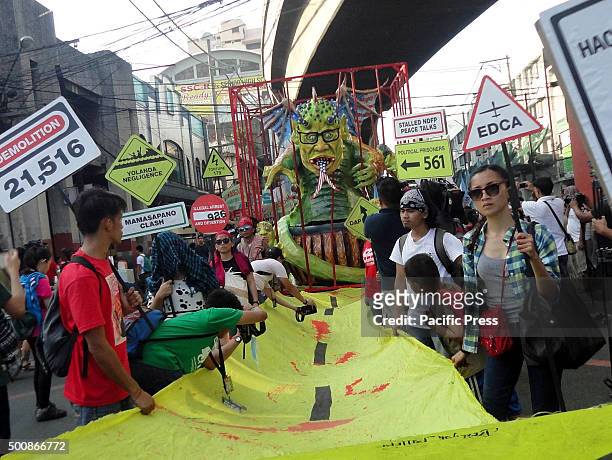 Bloodied yellow road," symbolic of the Philippine government's "Tuwid na Daan" policy leads to an effigy of Philippine President Benigno Aquino III,...