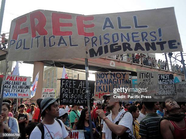 Filipino protesters hold placards calling to free alleged political prisoners in the country during a protest marking International Human Rights Day...