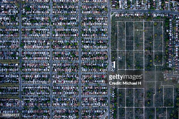 An aerial view of suburbian housing and cemetery