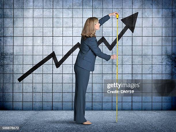 businesswoman measures growth with tape measure - measuring stock pictures, royalty-free photos & images