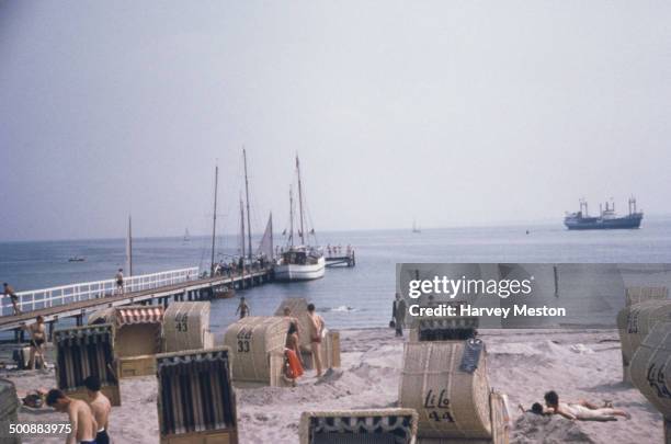 Travemünde beach in Lübeck, Germany, with its characteristic wicker beach chairs, circa 1960.