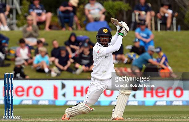 Dinesh Chandimal of Sri Lanka drives through the covers for 4 during day two of the First Test match between New Zealand and Sri Lanka at University...