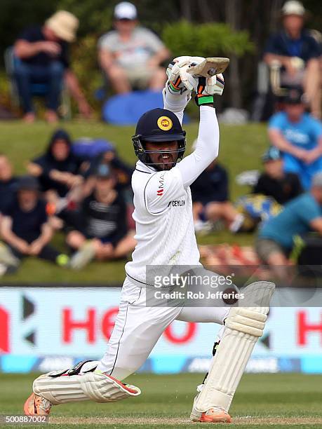 Dinesh Chandimal of Sri Lanka drives through the covers for 4 during day two of the First Test match between New Zealand and Sri Lanka at University...