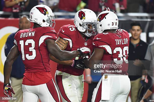 Wide receiver Michael Floyd of the Arizona Cardinals celebrates with teammates Stepfan Taylor and Jaron Brown after scoring a 42 yard touchdown...