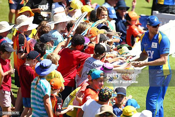 Freddie Flintoff of the Legends signs autographs for spectators during the WA Festival of Cricket Legends Match between the Australian Legends XI and...