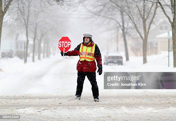 school crossing guard on a snowy wisconsin street - 交通誘導員 ストックフォトと画像
