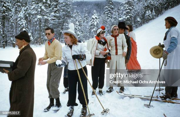 Actors play in the snow as the press covers the celebrities in town for the movie premiere of "Santa Fe Trail" in December 1940.