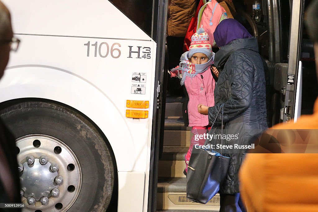 Syrian refugees begin to arrive in Canada at a hotel