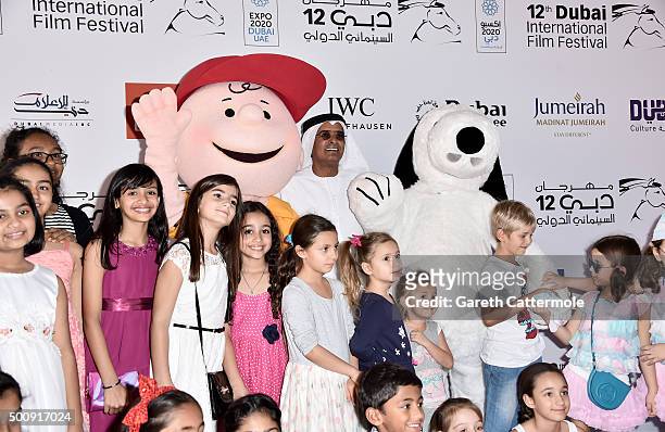 Character Charlie Brown, DIFF Chairman Abdulhamid Juma, character Snoopy and young guests attend "The Peanuts Movie" premiere during day three of the...