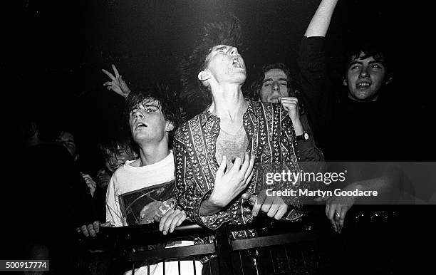 Indie fans absorbed in the music in the front rows of the crowd, watching the Soup Dragons perform in Rennes, France, 1990.