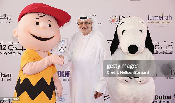 Character Charlie Brown, DIFF Artistic Director Masoud Amralla Al Ali and character Snoopy attend "The Peanuts Movie" premiere during day three of...
