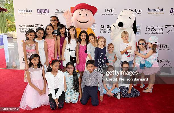 Characters Charlie Brown and Snoopy with guests as they attend "The Peanuts Movie" premiere during day three of the 12th annual Dubai International...