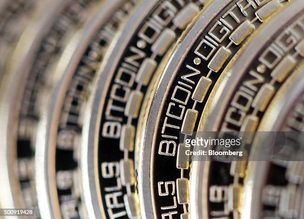 The embossed word Bitcoin sits on the edge of Bitcoins stacked in this arranged photograph in Danbury, U.K., on Thursday, Dec. 10, 2015. Bitcoin, the...