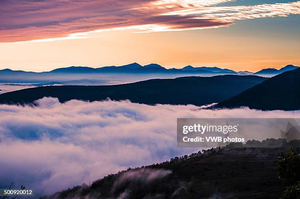 mountains rising through low cloud - allegory painting stock pictures, royalty-free photos & images