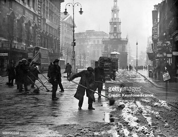 Cleaning the streets after the catastrophic floods in the center of London, United Kingdom, in January 1928.