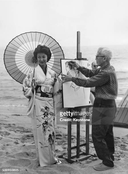 Japanese painter and printmaker Léonard Tsugouharu Foujita paints a portrait of Japanese actress and writer Keiko Kishi at the Cannes Film Festival,...