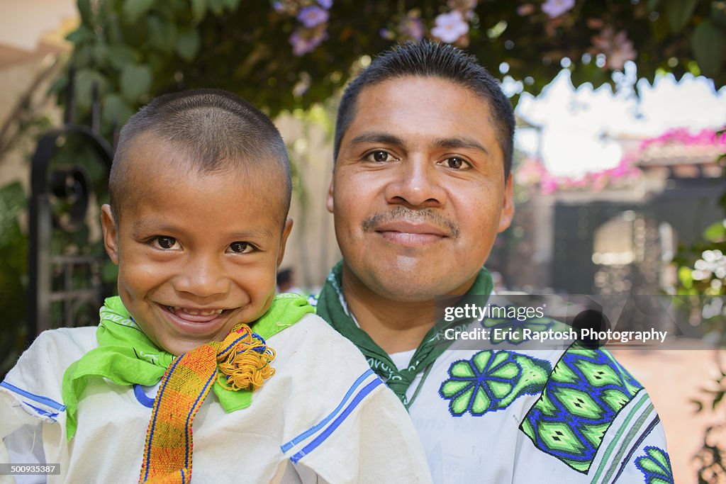 Wixaritari boy with father in traditional dress