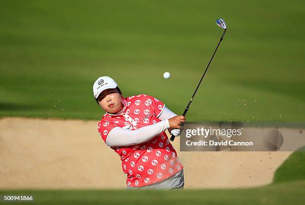 Shanshan Feng of China plays her third shot on the par 4, 14th hole during the third round of the 2015 Omega Dubai Ladies Masters on the Majlis...