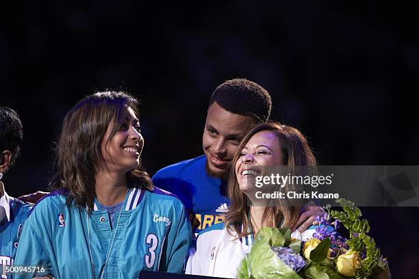 Golden State Warriors Stephen Curry on court with his sister Sydel Curry and mother Sonya Curry during ceremony to honor his father, former Charlotte...