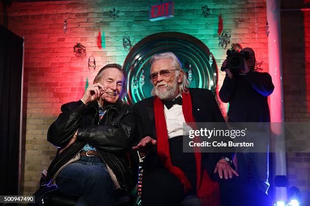 Legendary Canadian musicians Gordon Lightfoot, left, and Ronnie Hawkins, react to the playing of their new collaboration on an old 'The Band' song,...