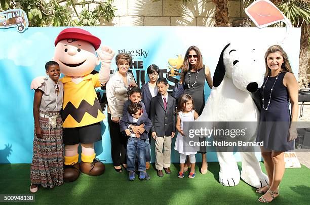 Characters Charlie Brown and Snoopy with guests as they attend "The Peanuts Movie" premiere during day three of the 12th annual Dubai International...