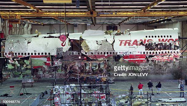 Wreckage of the front portion of the TWA flight 800 Boeing 747 aircraft is displayed in its reconstructed state 19 November in Calverton, Long...