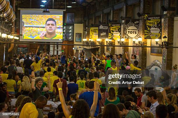 Brasil supporters encourage his team against Colombia during the Brazil 2014 FIFA World Cup football match. Barcelona July 4th of 2014. Catalonia,...