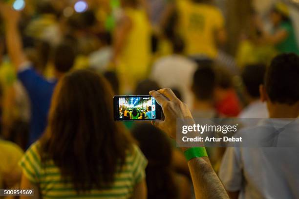 Brasil supporters encourage his team against Colombia during the Brazil 2014 FIFA World Cup football match. Barcelona July 4th of 2014. Catalonia,...