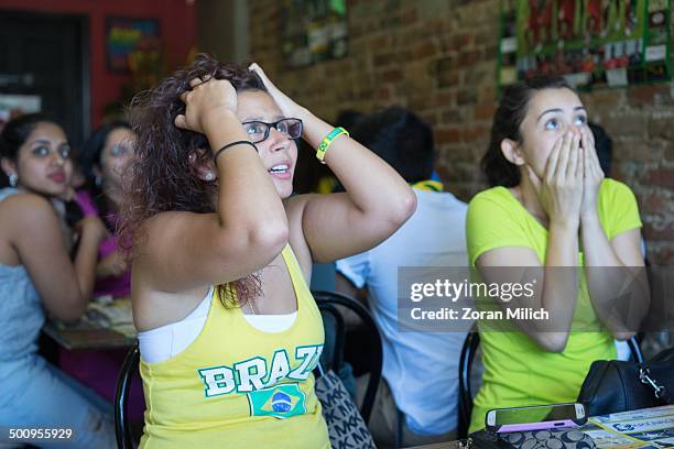 Soccer fans watch a FIFA World Cup match between Brazil and Columbia at The Brazilian Star Bar July 4, 2014 in Toronto, Ontario, Canada.