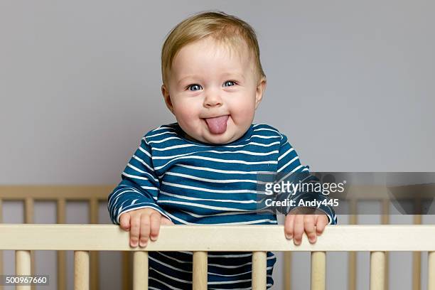 baby in the crib - sticking out tongue stock pictures, royalty-free photos & images