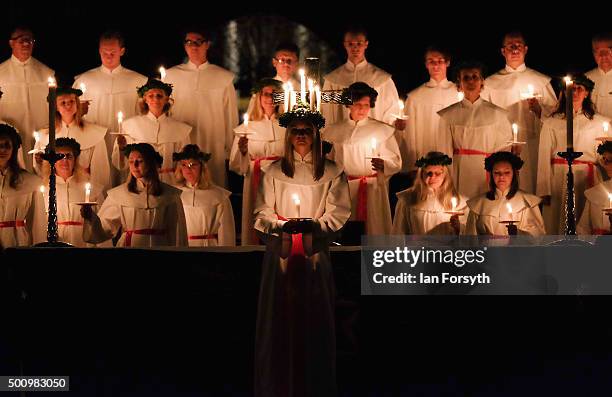 Sara Kjorling from Stockholm stands in front of the Chorus Pictor choir during the traditional Swedish festival of Sankta Lucia in York Minster on...