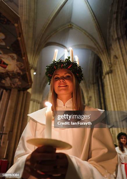 Sara Kjorling from Stockholm leads the procession during the traditional Swedish festival of Sankta Lucia at York Minster on December 11, 2015 in...