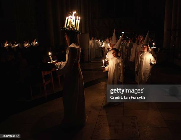 Sara Kjorling from Stockholm leads the procession during the traditional Swedish festival of Sankta Lucia at York Minster on December 11, 2015 in...