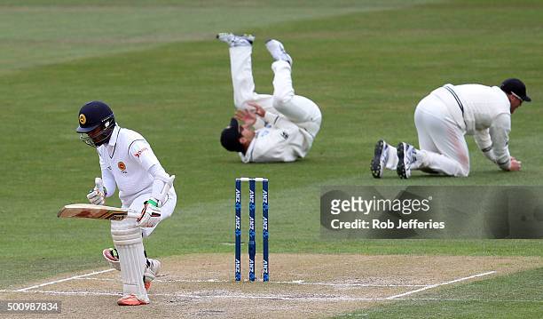 Martin Guptill of New Zealand successfully takes a catch off the bowling of Tim Southee to dismiss Dinesh Chandimal of Sri Lanka during day three of...