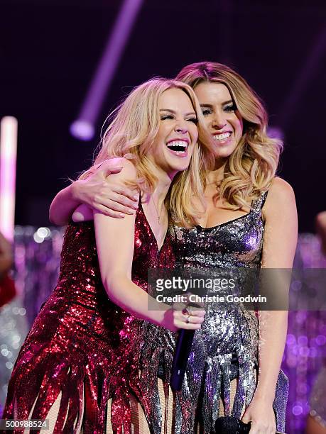 Kylie Minogue is joined by Dannii Minogue on stage during her Christmas show at the Royal Albert Hall on December 11, 2015 in London, England.