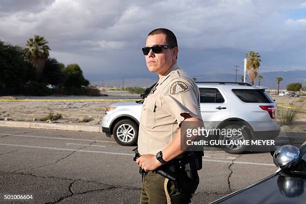 Police officer looks on near the Islamic Society of Palm Springs in Coachella, California on December 11 after the area was sealed off when a fire...
