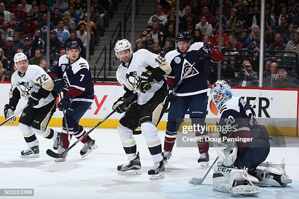 Goalie Reto Berra of the Colorado Avalanche watches a shot go wide as Erik Johnson, John Mitchell of the Colorado Avalanche, Eric Fehr and Patric...