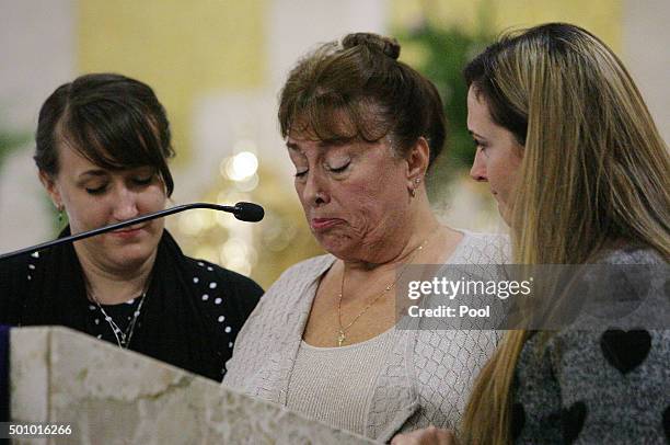 Trenna Meins speaks about her husband Damian Meins as her daughters Tawnya Meins and Tina Meins give support during his funeral at St. Catherine's of...